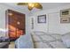 Cozy bedroom with ceiling fan and hardwood wardrobe for storage at 992 San Carlos Ne Ct, St Petersburg, FL 33702