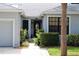 Inviting front exterior with well-manicured landscaping leading to a beautiful glass front door at 992 San Carlos Ne Ct, St Petersburg, FL 33702