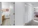 Hallway leading to a bathroom with a sink and countertop featuring a decorative closet space at 992 San Carlos Ne Ct, St Petersburg, FL 33702