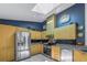 Bright kitchen with stainless steel appliances, light wood cabinets, and a modern backsplash at 992 San Carlos Ne Ct, St Petersburg, FL 33702