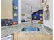 Granite countertop and sink overlooking a living space featuring an open floor plan and comfortable seating at 992 San Carlos Ne Ct, St Petersburg, FL 33702