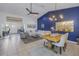 Living room and dining area with high ceilings, tiled floors, and a striking blue accent wall at 992 San Carlos Ne Ct, St Petersburg, FL 33702