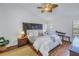 Comfortable main bedroom features a large bed, hardwood floors, and ample natural light at 992 San Carlos Ne Ct, St Petersburg, FL 33702