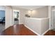 Upstairs hallway with hardwood flooring and neutral paint scheme, leading to bedroom at 10218 Summer Azure Dr, Riverview, FL 33578