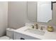 Bathroom featuring a white vanity with a white countertop, gold faucet, and modern mirror at 10249 Villa Palazzo Ct, Tampa, FL 33615