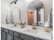 Bathroom featuring dual sinks, quartz countertops, and modern fixtures at 10249 Villa Palazzo Ct, Tampa, FL 33615