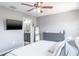 Bedroom with a TV, dresser and doorway to the bathroom, creating a functional and inviting space at 10249 Villa Palazzo Ct, Tampa, FL 33615