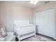 Bright Bedroom with a white crib and spacious closet at 10249 Villa Palazzo Ct, Tampa, FL 33615