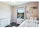 Bright Bedroom with a white dresser, chair, and window at 10249 Villa Palazzo Ct, Tampa, FL 33615
