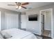 Bedroom featuring two closets, a door and a mounted TV creating a functional and comfortable living space at 10249 Villa Palazzo Ct, Tampa, FL 33615