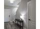 Bright foyer featuring wood-look floors, a sleek console table, and a welcoming ambiance at 10249 Villa Palazzo Ct, Tampa, FL 33615