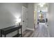 Clean hallway featuring wood-look floors leading to the open and spacious living area at 10249 Villa Palazzo Ct, Tampa, FL 33615
