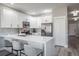 Modern kitchen with white cabinets, stainless steel appliances, quartz countertops, and a tile backsplash at 10249 Villa Palazzo Ct, Tampa, FL 33615