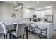 Modern kitchen featuring white cabinets, stainless steel appliances, and a large island with bar seating at 10249 Villa Palazzo Ct, Tampa, FL 33615