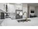 Modern kitchen features white cabinets, stainless steel appliances, and bright countertops at 10249 Villa Palazzo Ct, Tampa, FL 33615