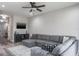 Bright living room with a large sectional, TV, and modern decor, perfect for relaxation and entertaining at 10249 Villa Palazzo Ct, Tampa, FL 33615