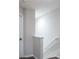 Bright stairwell featuring white walls, white railing and the entrance to the basement at 10249 Villa Palazzo Ct, Tampa, FL 33615