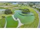 Aerial view showcasing the green landscaped community with a unique water feature and ponds at 10389 Echo Dock Loop, San Antonio, FL 33576