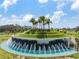 Stunning community entrance featuring a water fountain, lush landscaping, and the 'Mirada' sign at 10389 Echo Dock Loop, San Antonio, FL 33576
