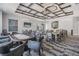 A cozy game room with comfortable seating, stylish ceiling feature, and a large television at 10389 Echo Dock Loop, San Antonio, FL 33576