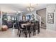 Open-concept dining room with a view to the living room and staircase at 10389 Echo Dock Loop, San Antonio, FL 33576