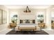 Bedroom suite showcasing natural light, decorative pillows, side tables and chandelier at 106 Lilyan Ct, Rotonda West, FL 33947