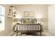 Relaxing bedroom showcasing a rod-iron bed frame, neutral color palette, wall decor, and plenty of natural light at 106 Lilyan Ct, Rotonda West, FL 33947