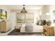 Bright bedroom with chandelier, neutral walls, decorative art, and soft textures at 106 Lilyan Ct, Rotonda West, FL 33947