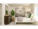 Comfortable bedroom featuring a bead-board bed, stylish chandelier, neutral color palette, and ample natural light at 106 Lilyan Ct, Rotonda West, FL 33947