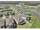Aerial view of neighborhood with sidewalks and well manicured lawns surrounding calm lakes at 10845 Sundrift Dr, Tampa, FL 33647