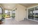 Enclosed patio with tile flooring and views of the backyard at 10845 Sundrift Dr, Tampa, FL 33647