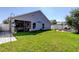 Exterior shot of a well-maintained home showcasing a lush green lawn and an inviting outdoor patio area at 11207 Cypress Reserve Dr, Tampa, FL 33626