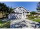 Charming single-story home with a two-car garage, lush landscaping, and well-manicured lawn at 11207 Cypress Reserve Dr, Tampa, FL 33626