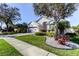 Charming home featuring a well-manicured lawn, attractive landscaping, and mature shade trees at 11207 Cypress Reserve Dr, Tampa, FL 33626