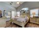 A spacious main bedroom features natural lighting, hard wood floors, and a walk-in bathroom at 11207 Cypress Reserve Dr, Tampa, FL 33626