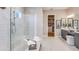 Bright bathroom featuring a walk-in glass shower, a dual sink vanity, and decorative touches at 11326 Viani Ter, Palmetto, FL 34221