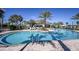 Resort-style community pool with lounge chairs, palm trees, and clear blue water at 11326 Viani Ter, Palmetto, FL 34221