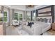 Expansive main bedroom featuring a seating area, patterned curtains and a stunning chandelier at 11326 Viani Ter, Palmetto, FL 34221