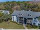 Scenic aerial view of condos surrounded by lush landscaping and mature palm trees at 1182 Pine Ridge W Cir # B1, Tarpon Springs, FL 34688