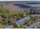 Aerial view showcasing community amidst a backdrop of serene wooded surroundings at 1182 Pine Ridge W Cir # B1, Tarpon Springs, FL 34688