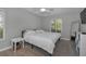 Comfortable bedroom features a plush bed, ceiling fan, and a bright window at 1182 Pine Ridge W Cir # B1, Tarpon Springs, FL 34688