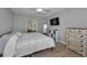Inviting bedroom featuring a comfortable bed, TV, and ample storage at 1182 Pine Ridge W Cir # B1, Tarpon Springs, FL 34688