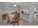 Cozy dining area with wood chairs, table, and a pass-through to the bright, white kitchen at 1182 Pine Ridge W Cir # B1, Tarpon Springs, FL 34688