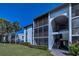Striking view of condos featuring screened in balconies under a bright blue sky at 1182 Pine Ridge W Cir # B1, Tarpon Springs, FL 34688