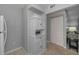 Hallway featuring white pantry with a view to the living room at 1182 Pine Ridge W Cir # B1, Tarpon Springs, FL 34688