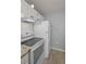 A glimpse of the kitchen featuring a white refrigerator, stove, and laminate flooring at 1182 Pine Ridge W Cir # B1, Tarpon Springs, FL 34688