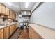 Functional kitchen with wood cabinets, essential appliances, and ample counter space at 1182 Pine Ridge W Cir # B1, Tarpon Springs, FL 34688