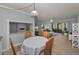 Bright living area with access to screened lanai, hardwood flooring, and open floorplan at 1182 Pine Ridge W Cir # B1, Tarpon Springs, FL 34688