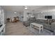 Open concept living room with modern decor, dining space, and a view of the kitchen at 1182 Pine Ridge W Cir # B1, Tarpon Springs, FL 34688