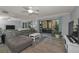 Spacious living room with sliding glass doors to patio, ceiling fan, and modern decor at 1182 Pine Ridge W Cir # B1, Tarpon Springs, FL 34688